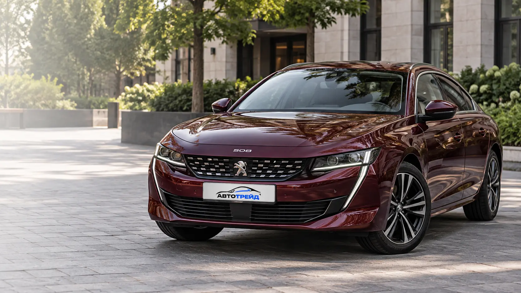 Бордовый Peugeot 508 во дворе у современного здания